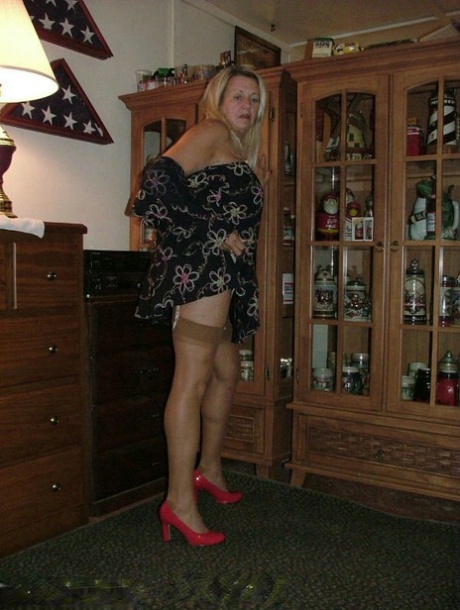 Fat grandmother with blonde hair exposes herself in tan nylons and garters