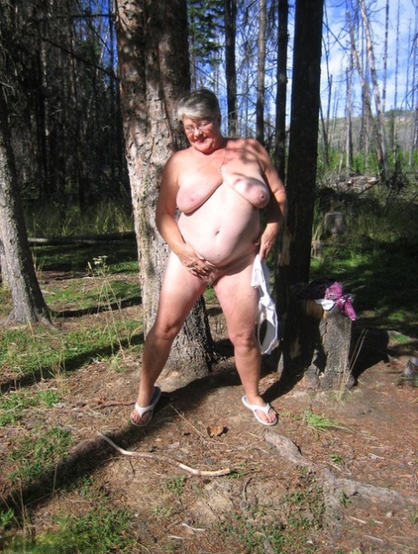Fat granny Girdle Goddess loses her purple outfit in the woods and poses nude